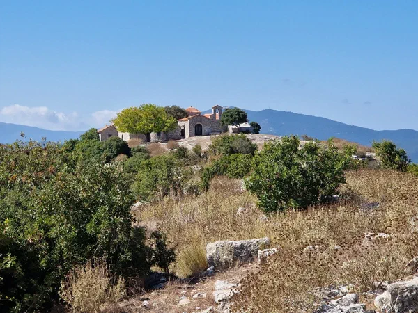Chapel on a hilltop ridge, the mountains behind